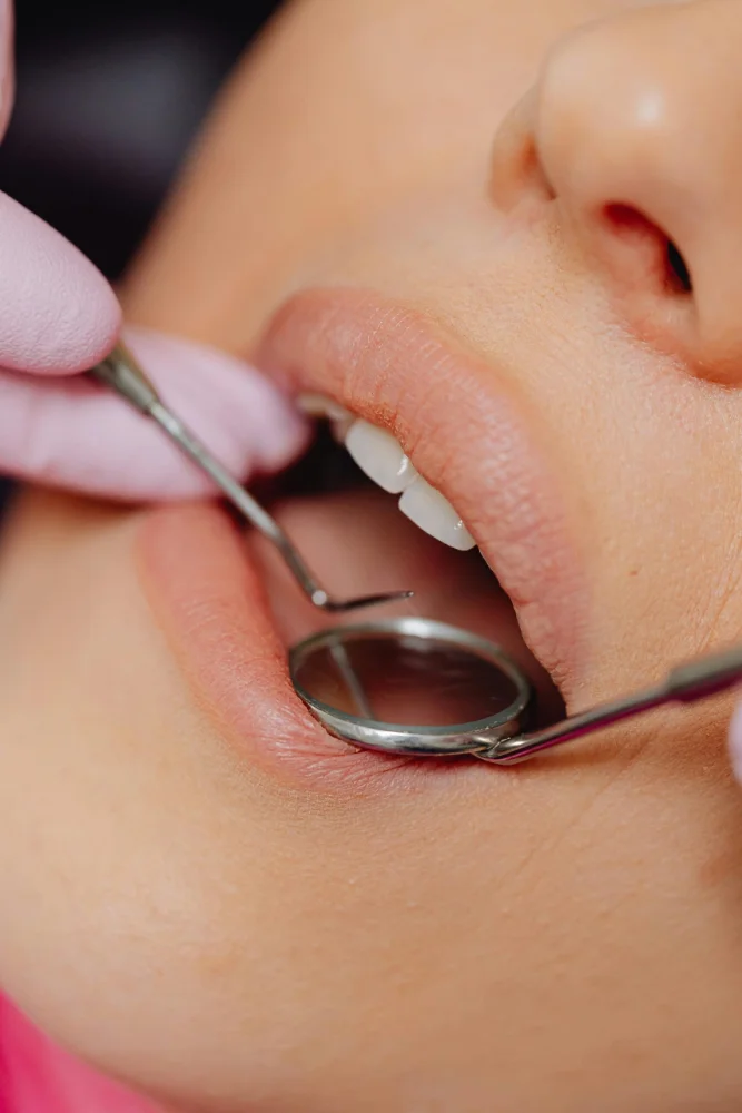 Dr. Monique Sison performing a gentle oral cancer screening at mend dental in Irvine
